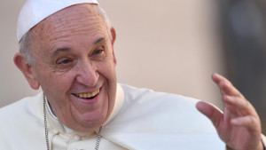 Pope Francis smiles as he arrives to lead  weekly audience in St. Peter's Square at Vatican